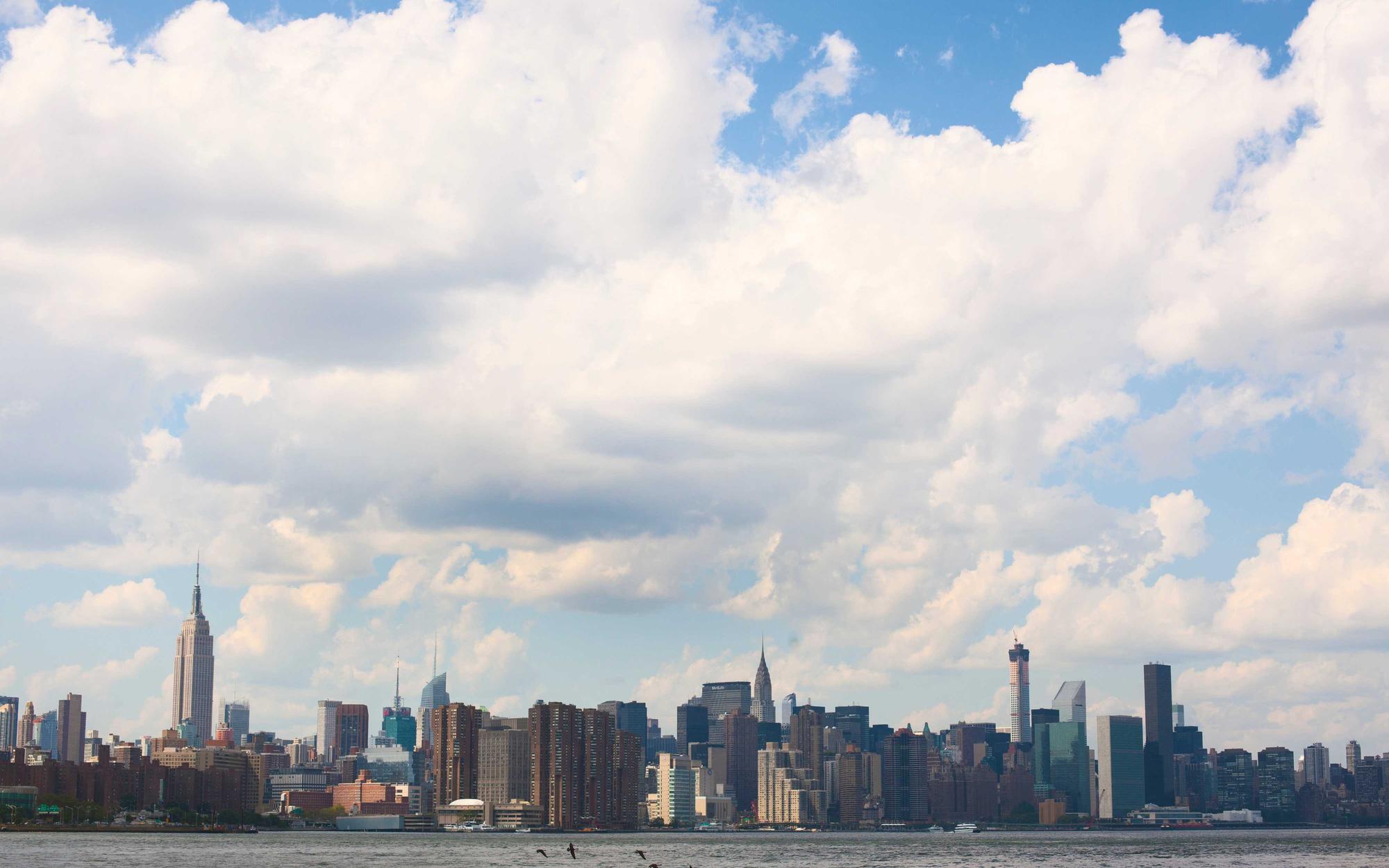 City skyline across the water under a wide sky